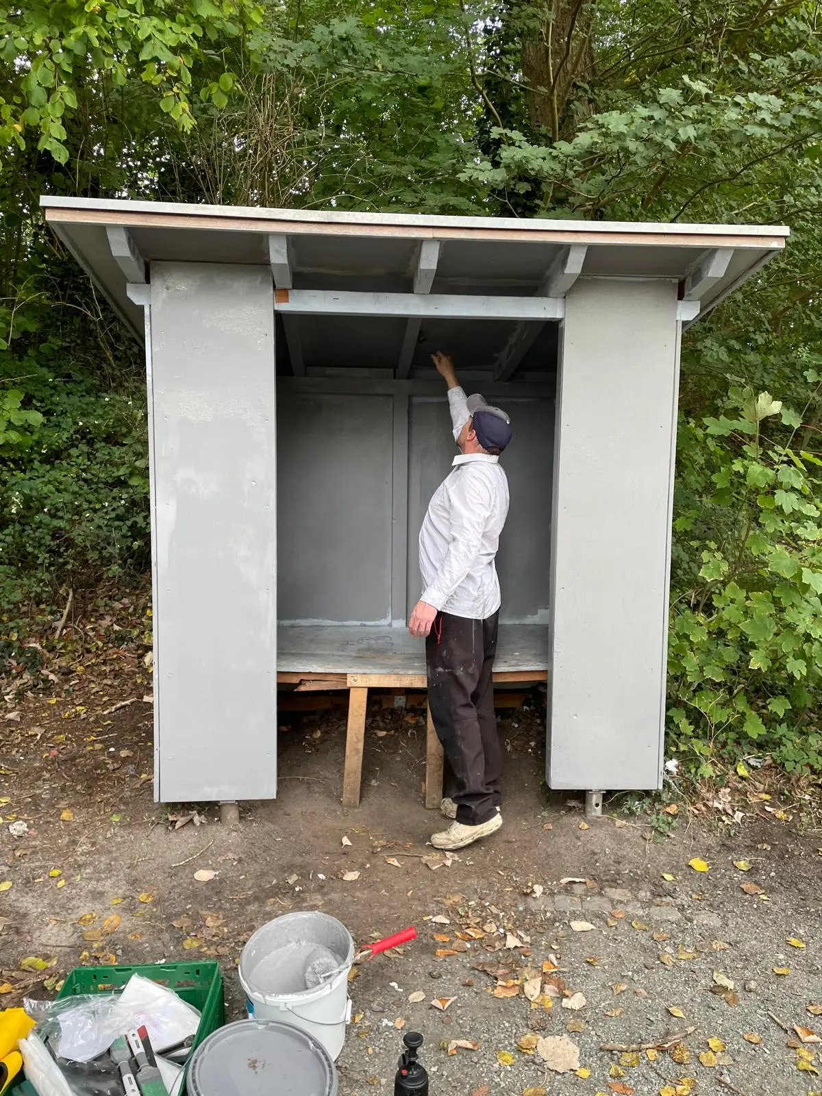 Helfer streicht die Innenwände der Schutzhütte